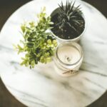 white votive candle near plant pot