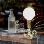 selective focus photography of lamp and bottles with glassware